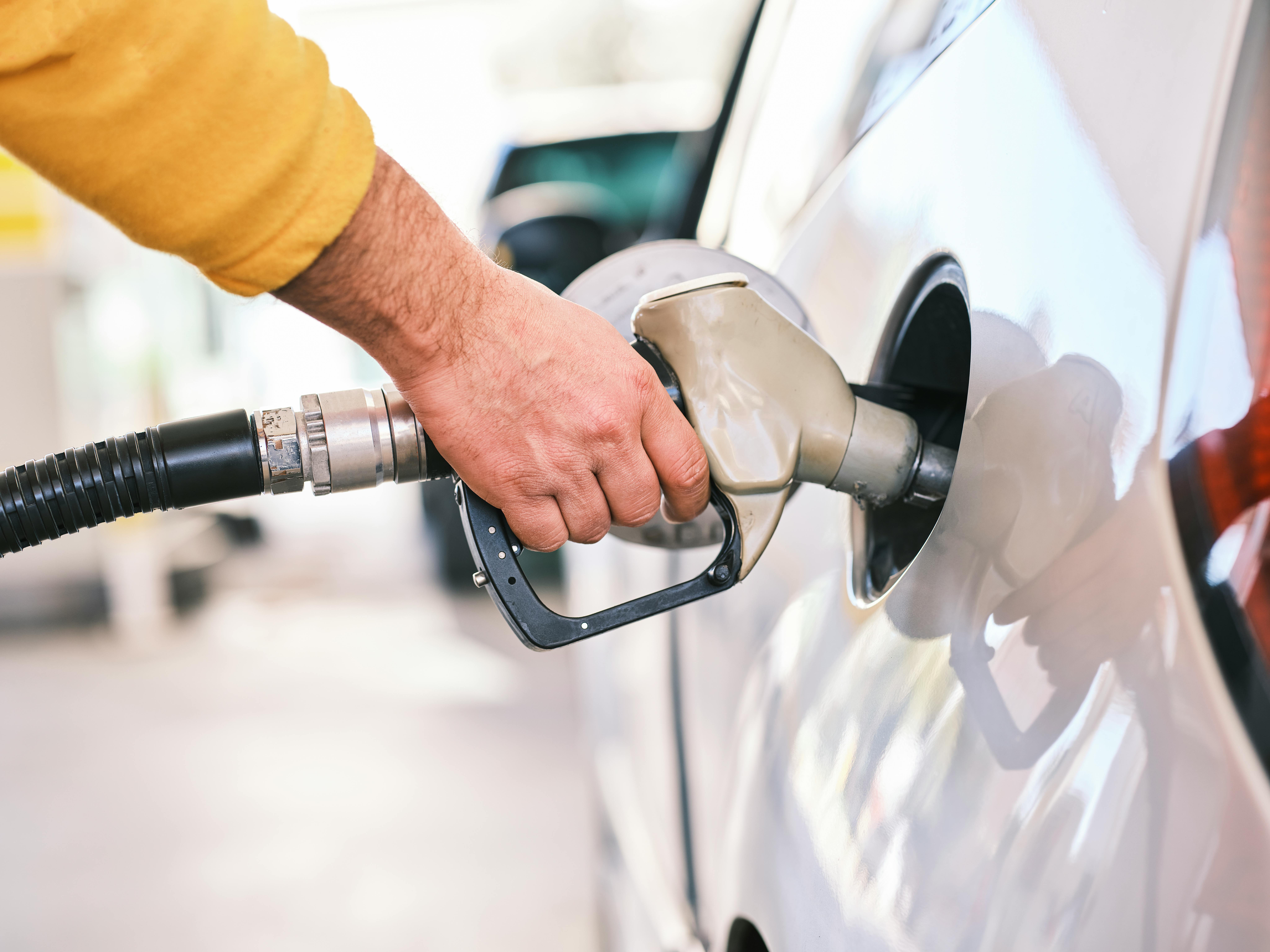 man putting in gas