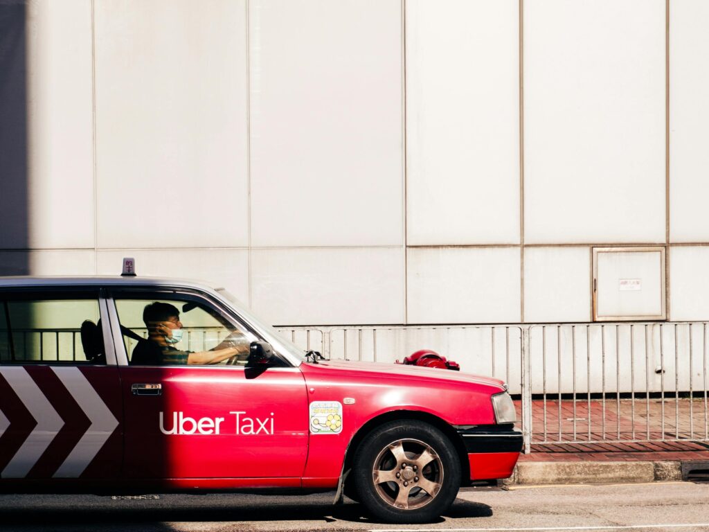 red uber taxi in the light