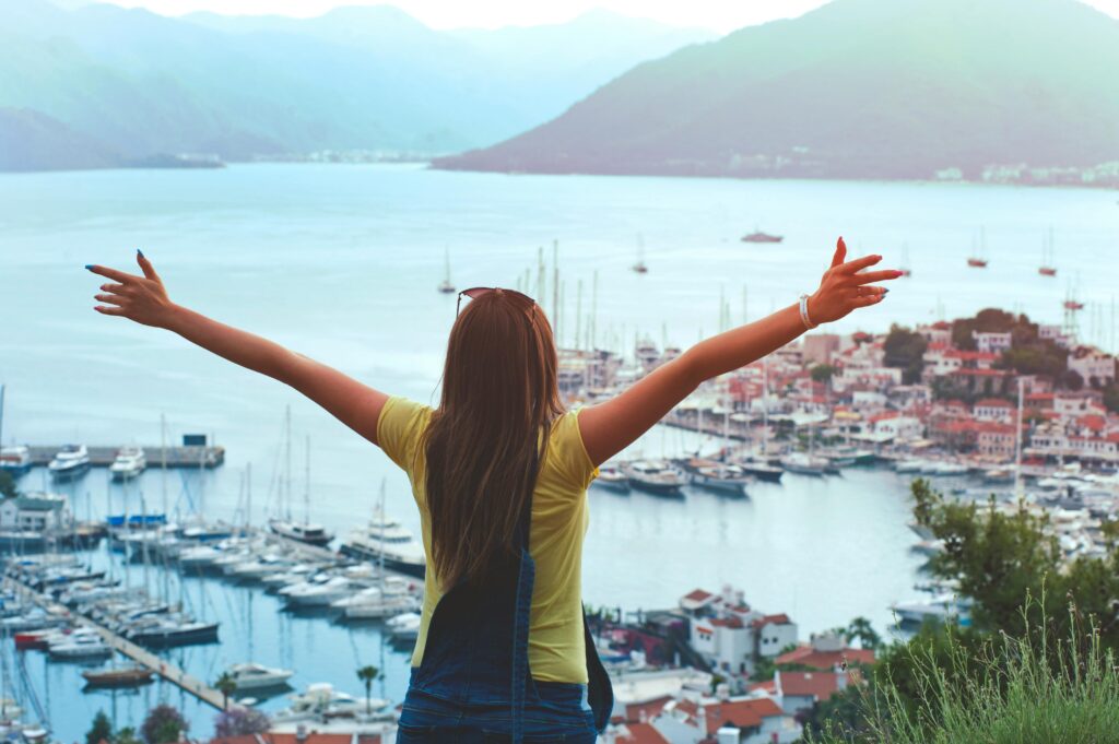 woman with arms out looking at the view
