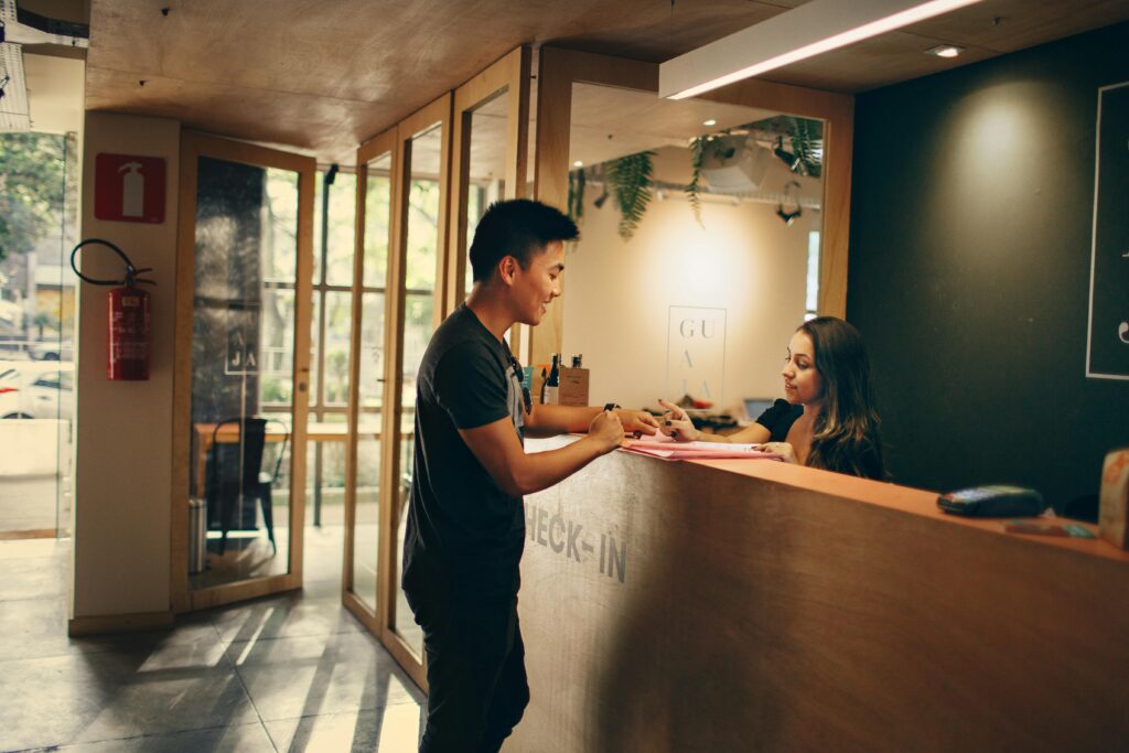 man at hotel reception desk