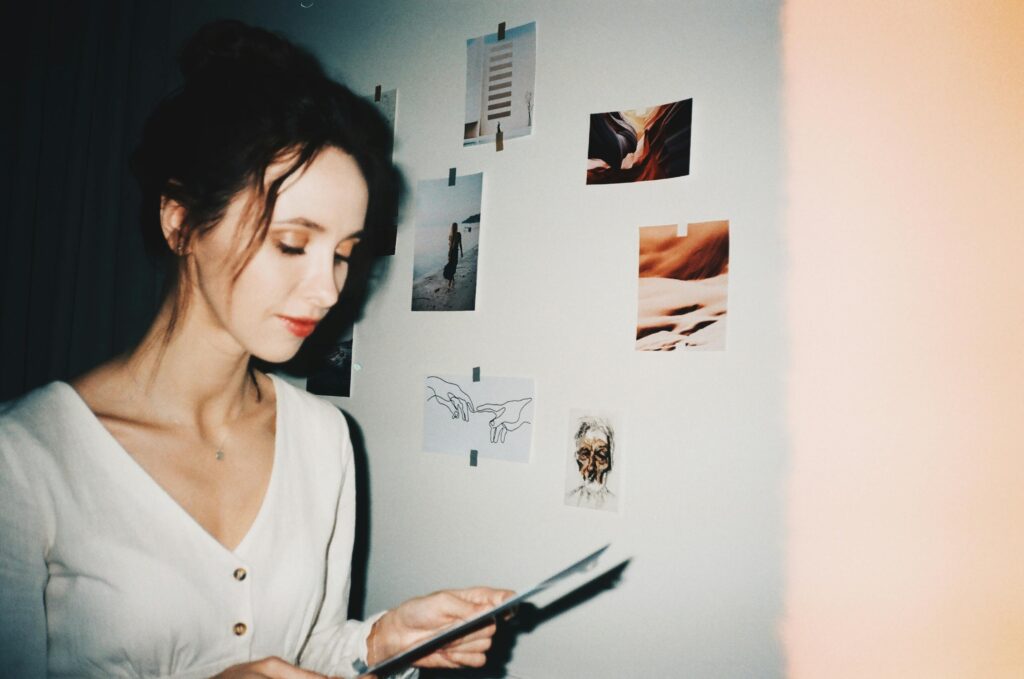 woman standing next to a white wall