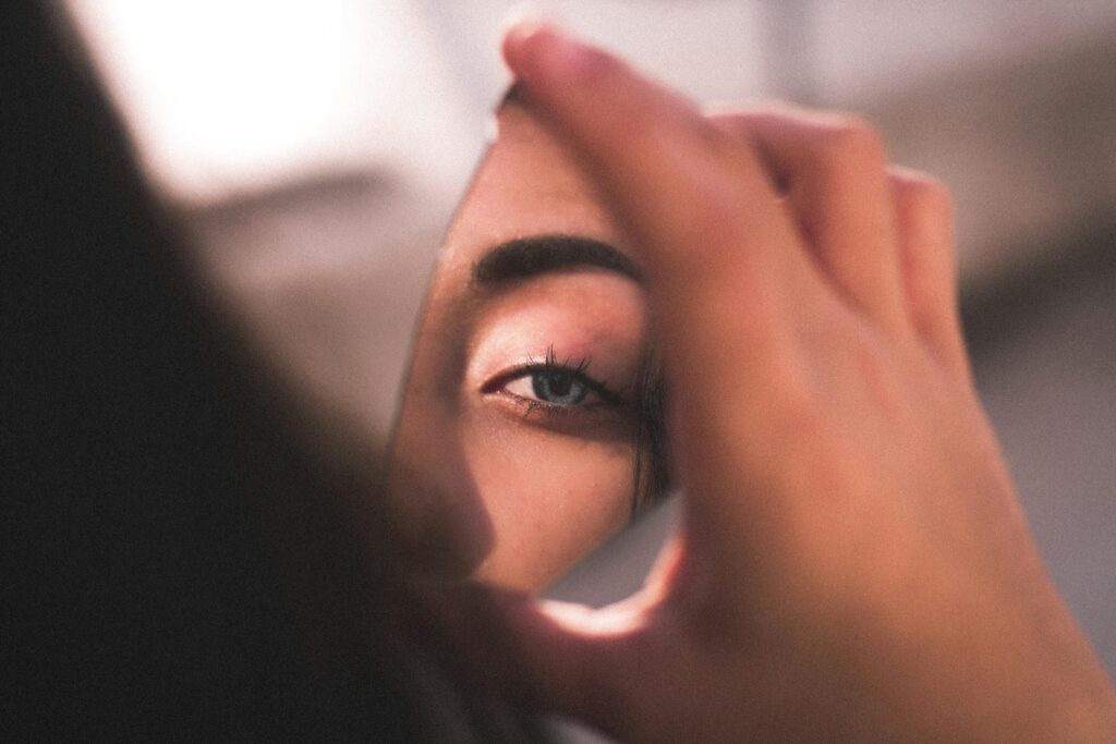 woman looking in mirror