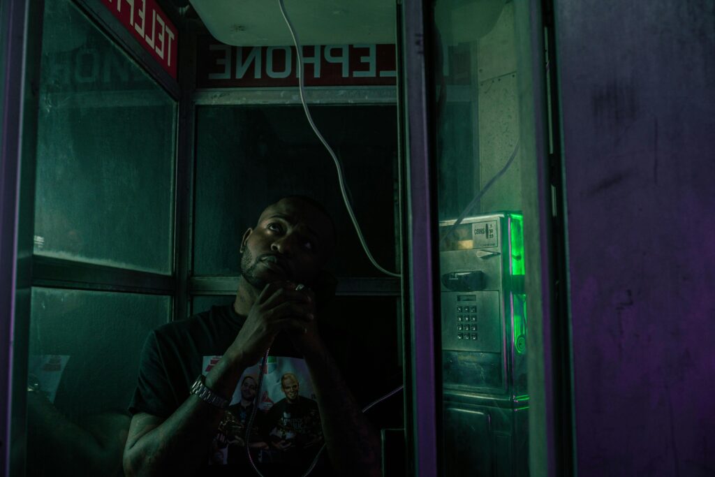 man using a pay phone