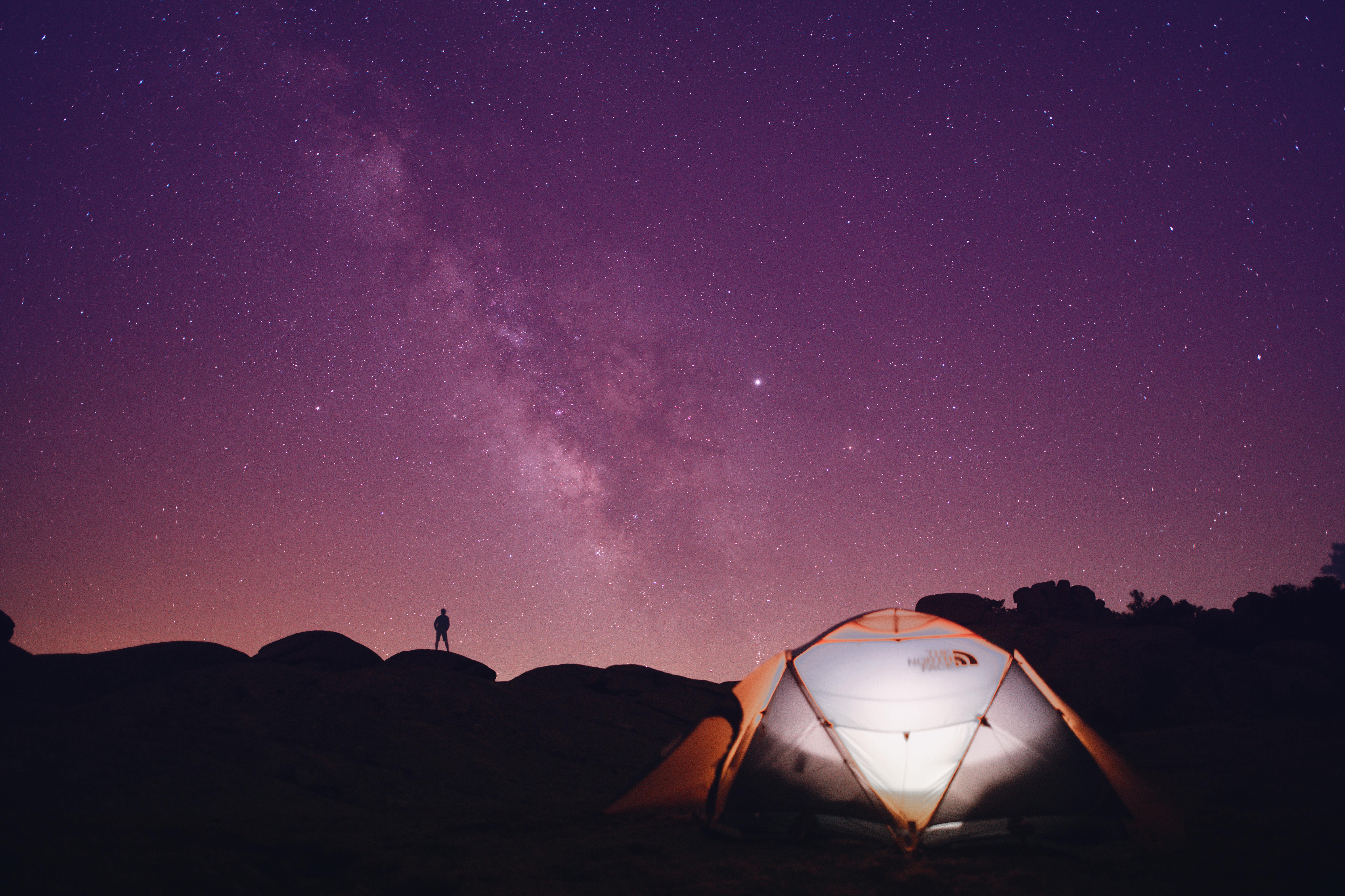 man with tent at night 