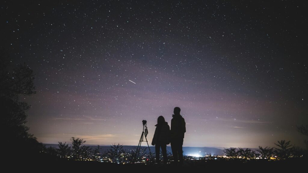 people looking at the night sky