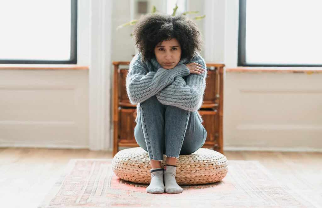 woman sitting on pillow