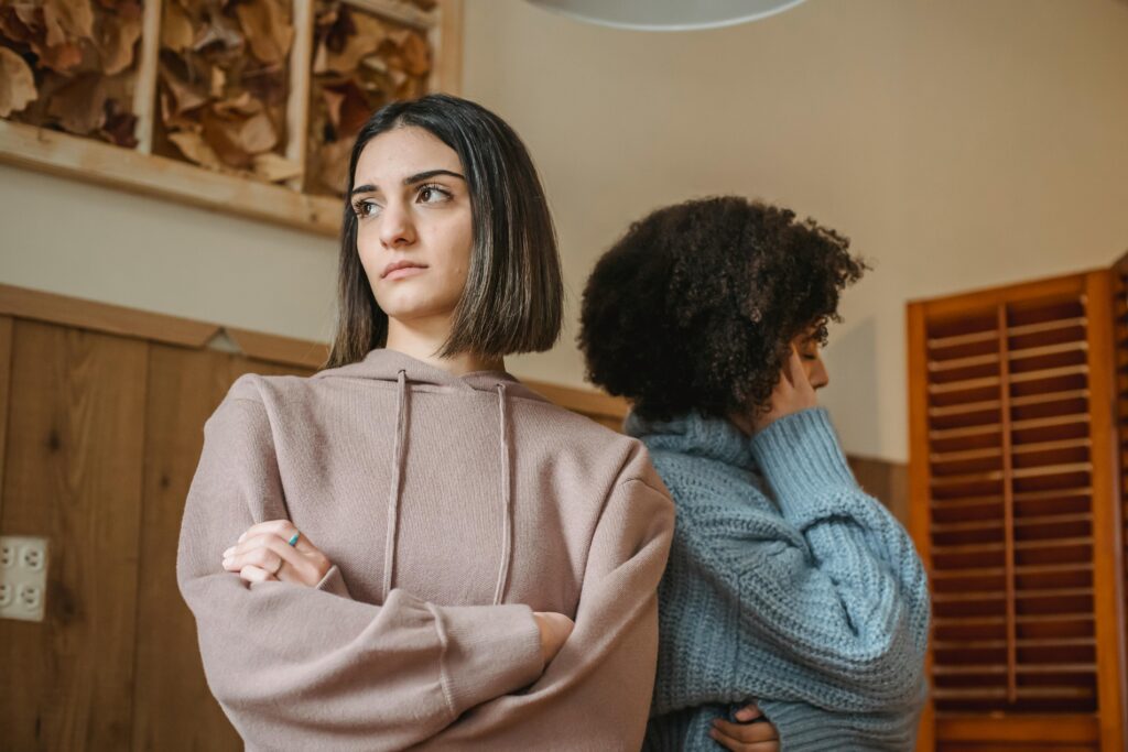 woman wearing beige looking dissapointed