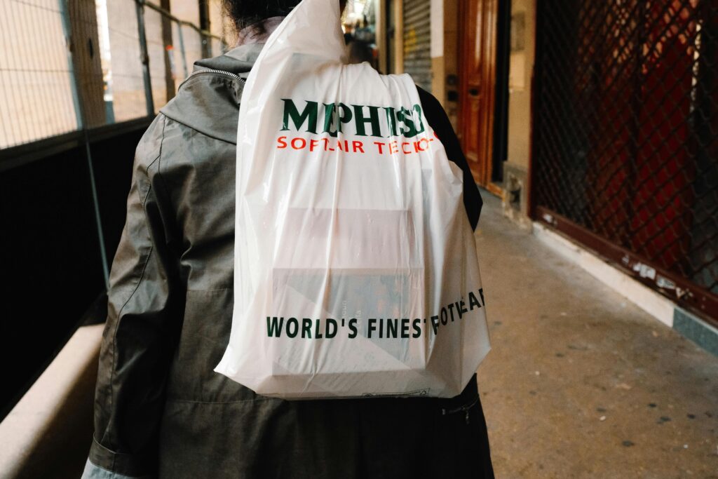 image of person carrying plastic bag 