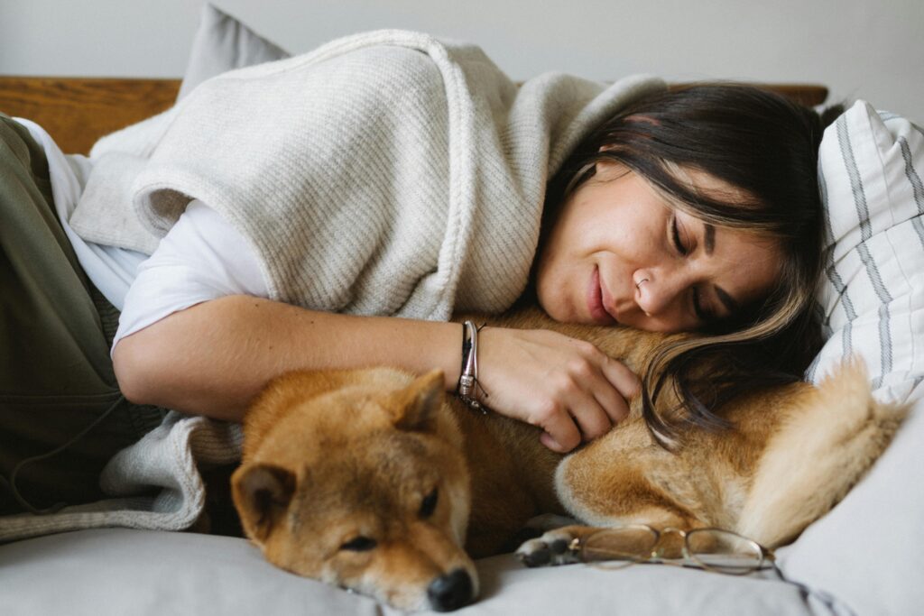 woman cuddling her dog