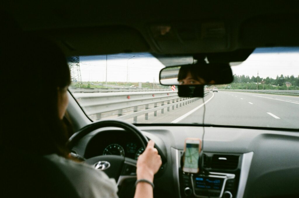 woman uber driver looking in mirror
