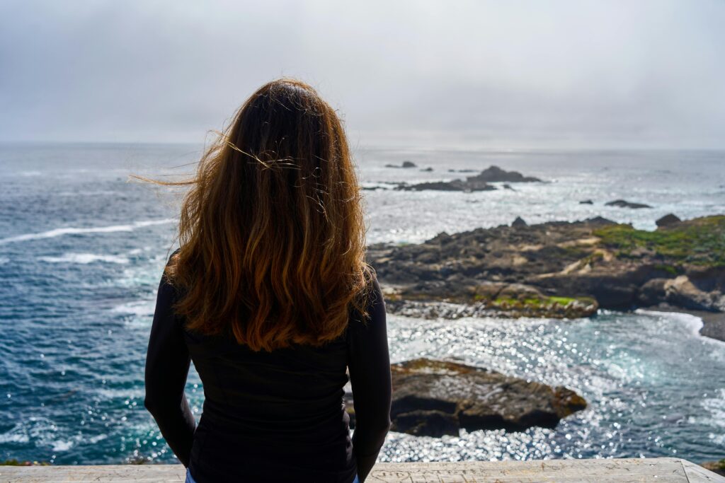 woman looking at the ocean