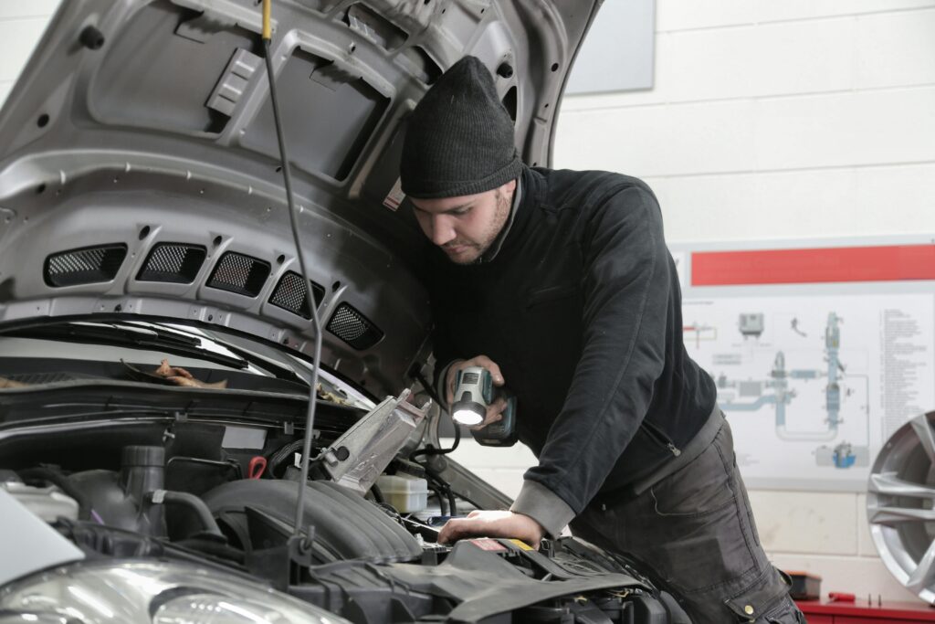 mechanic looking at car
