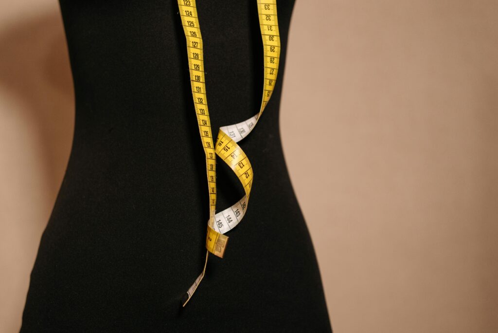 mannequin with measuring tape