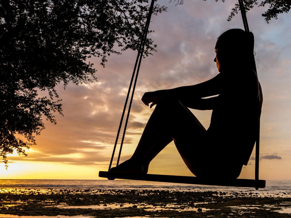 woman sitting on swing