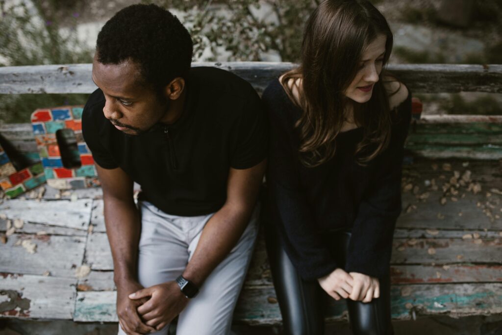 sad couple sitting on bench