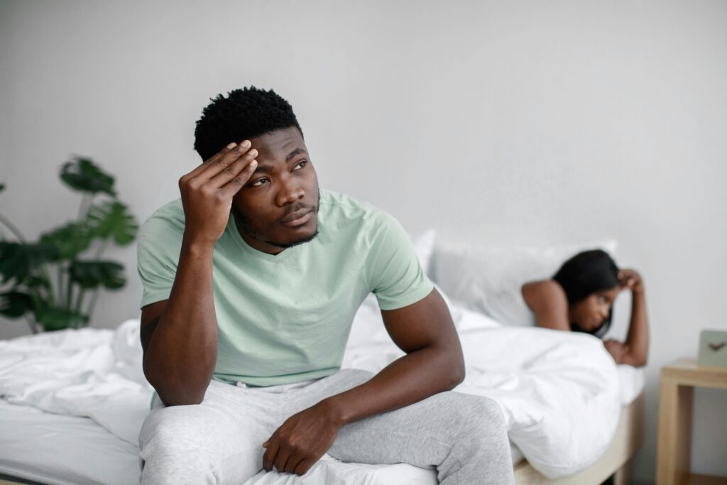 sad couple on bed
