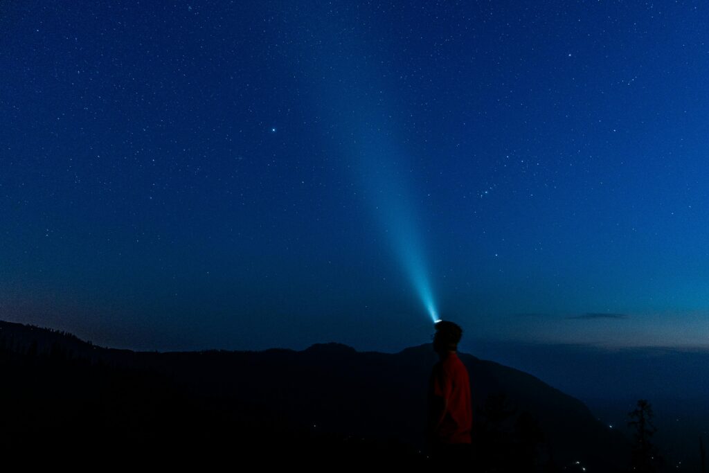 man with flashlight at night 