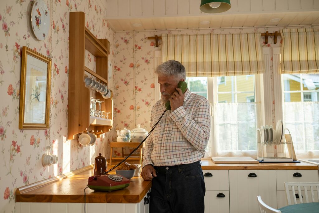man talking on landline phone