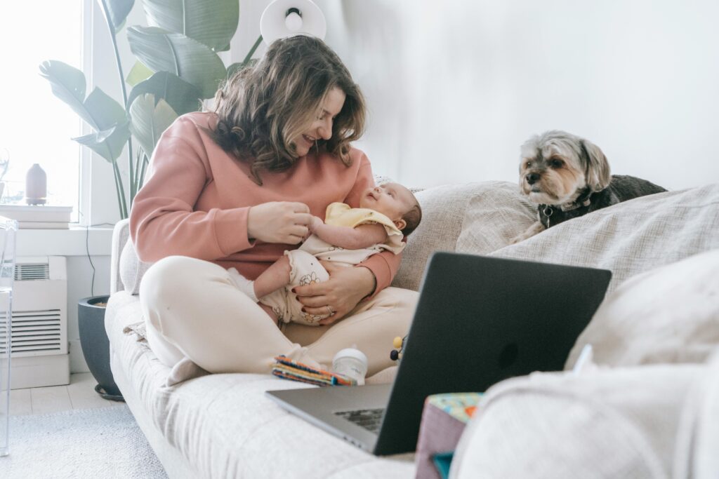 woman holding baby on couch