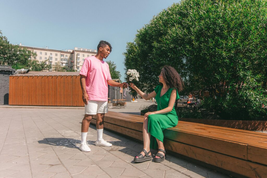 man giving woman flowers