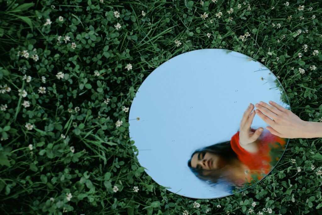 woman looking at mirror