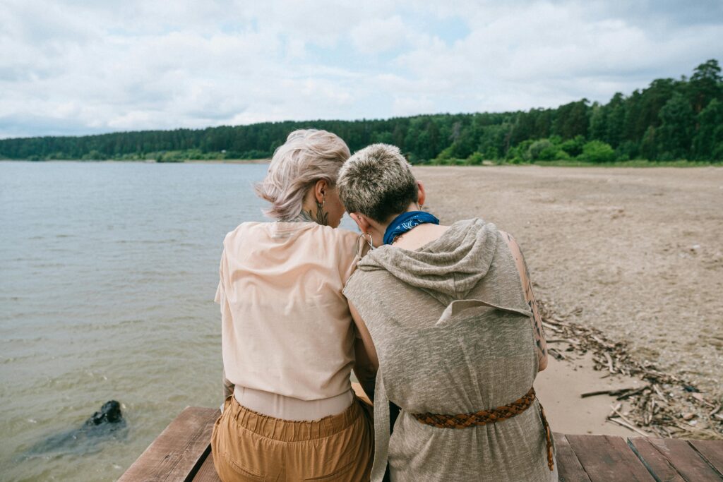 two women sitting at beach