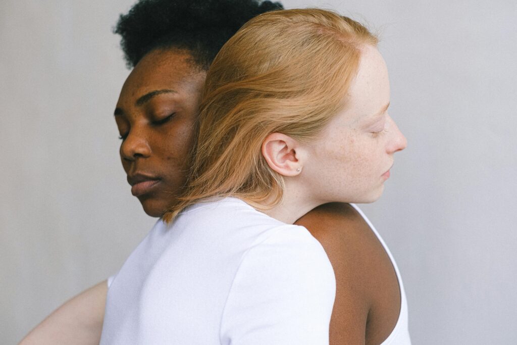 multi racial women hugging