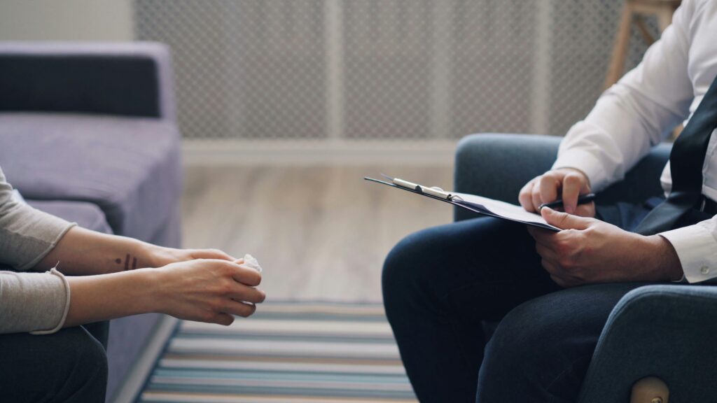 young person sitting in a therapy session
