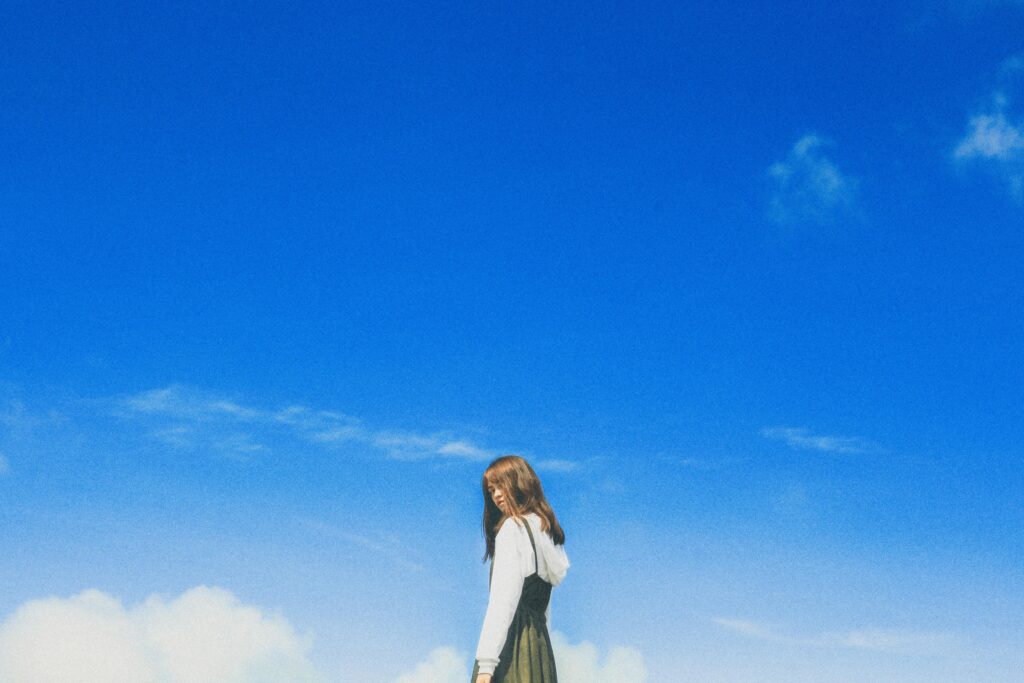image of woman and blue sky