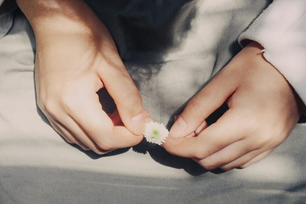 woman holing a little flower