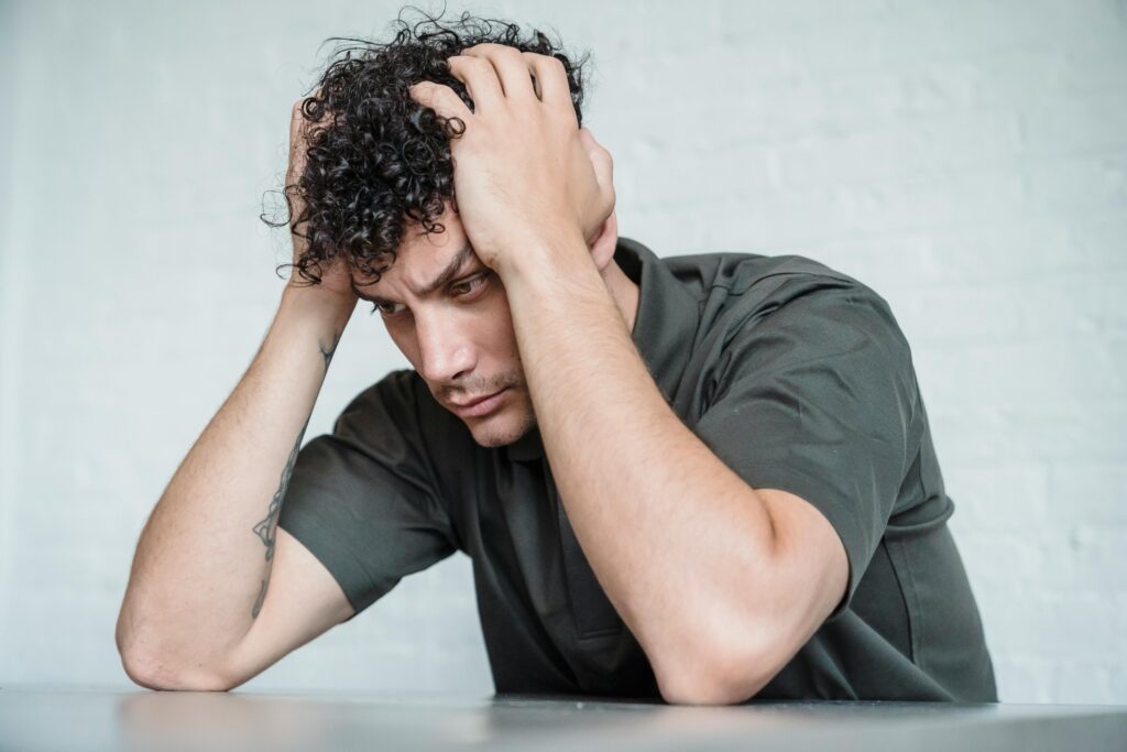 stressd man wearing green shirt