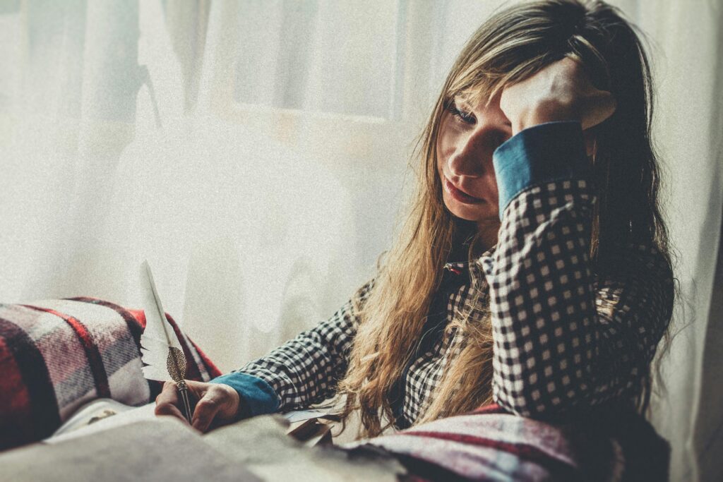 sad woman journaling