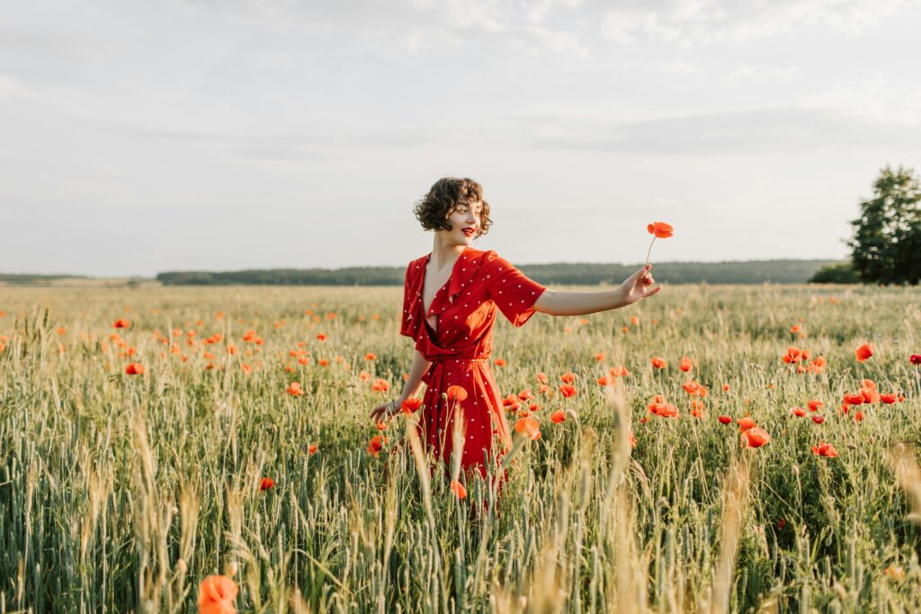 woman in red dress in field