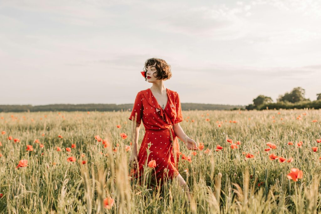 woman wearing red dress in flower field