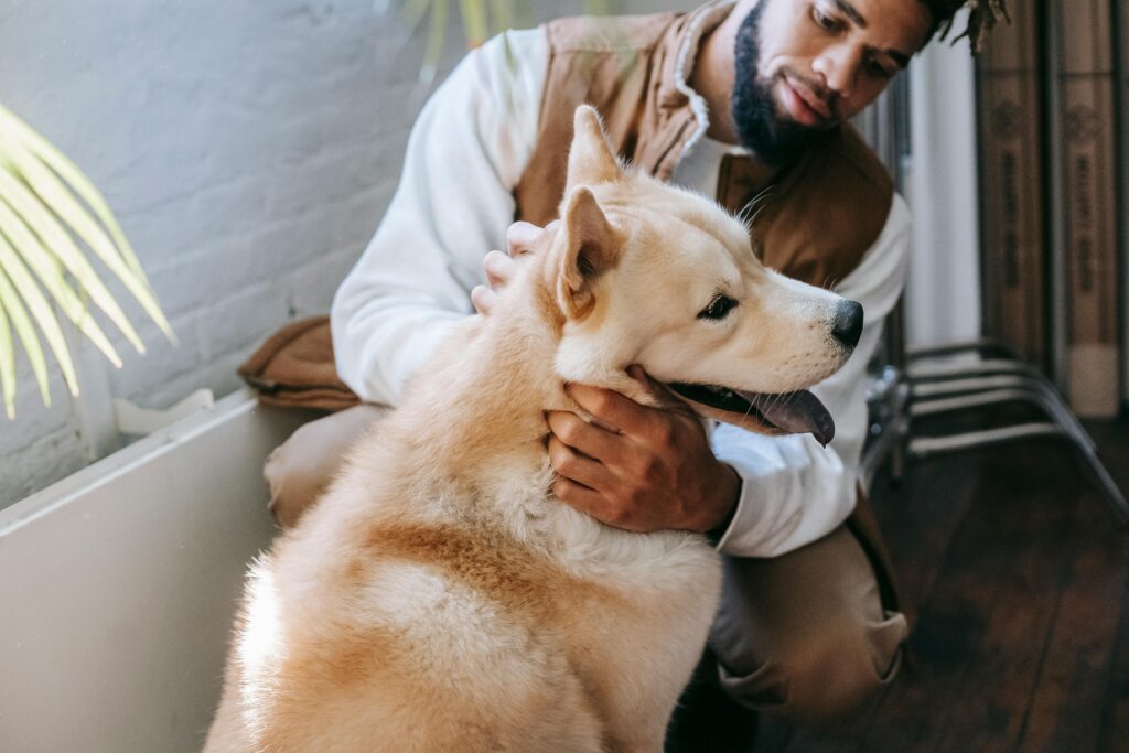 man with white fluffy dog