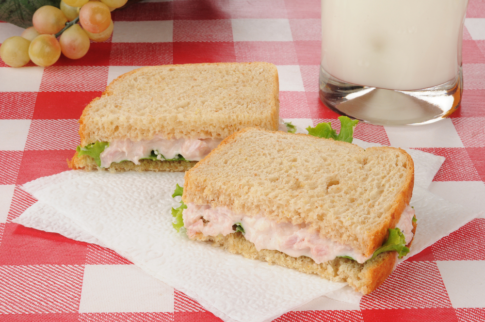 A deviled ham sandwich and a glass of milk