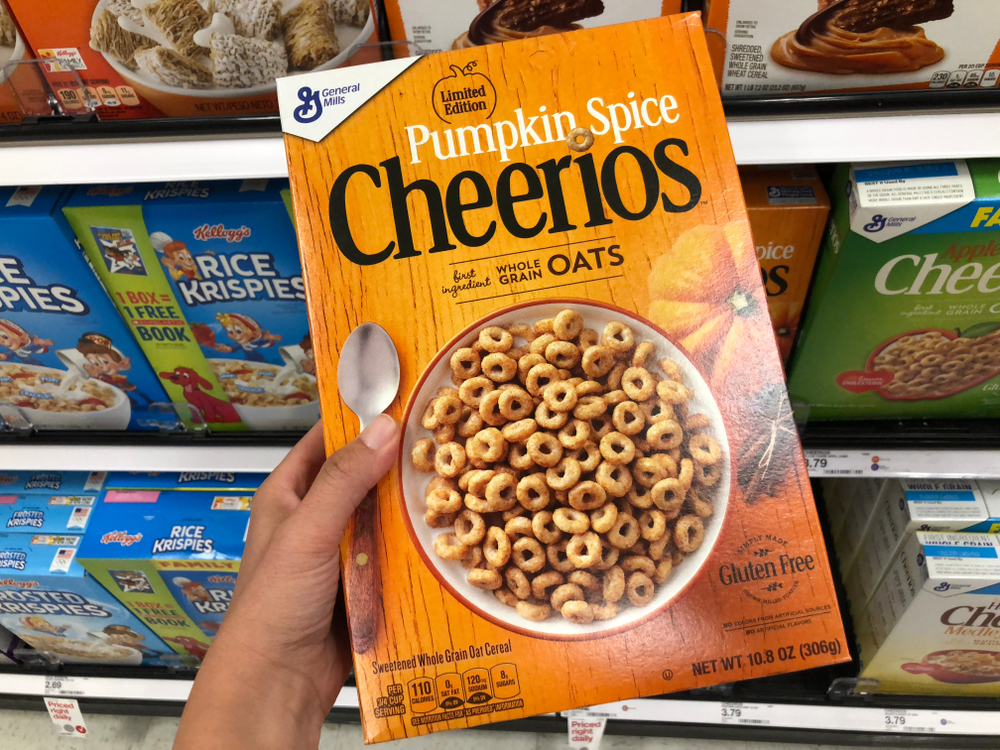 SEPTEMBER 25 2018 - CRYSTAL, MN: Customer holds up a box of Pumpkin Spice flavored Cheerios by General Mills, in a supermarket. This is a limited edition special flavor for fall