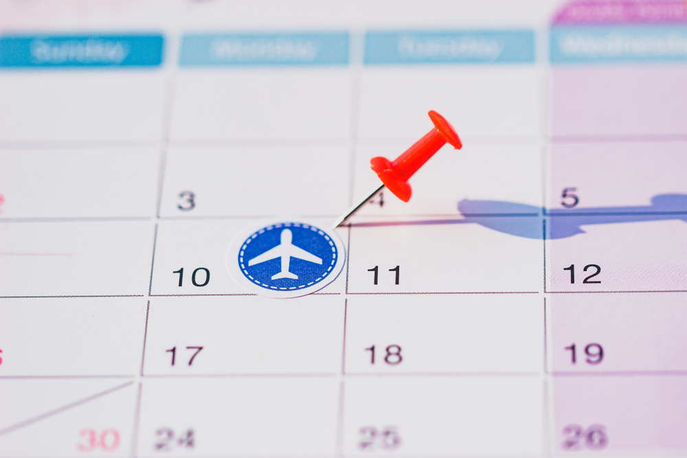 Calendar with push pin and plane stickers.