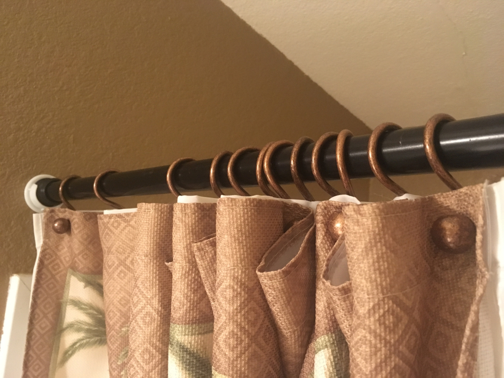 Close Up of Shower Curtain Rings Hanging on Shower Curtain Rod
