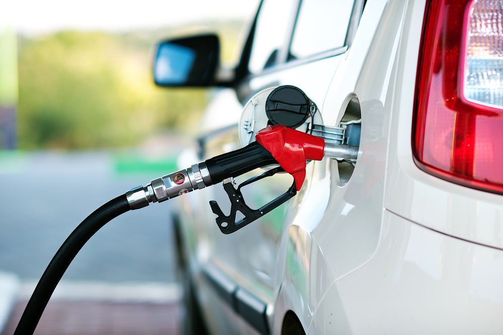 To fill the machine with fuel. Mashunya fill with gasoline at a gas station. Gas station pump. Man filling gasoline fuel in car holding nozzle. Close up.
