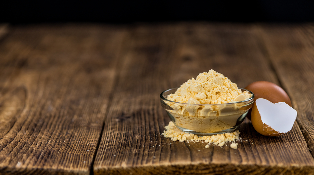 powdered eggs on wooden table