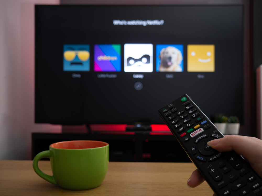 UK, March 2020: TV Television Netflix profile selection page who's watching with remote control
