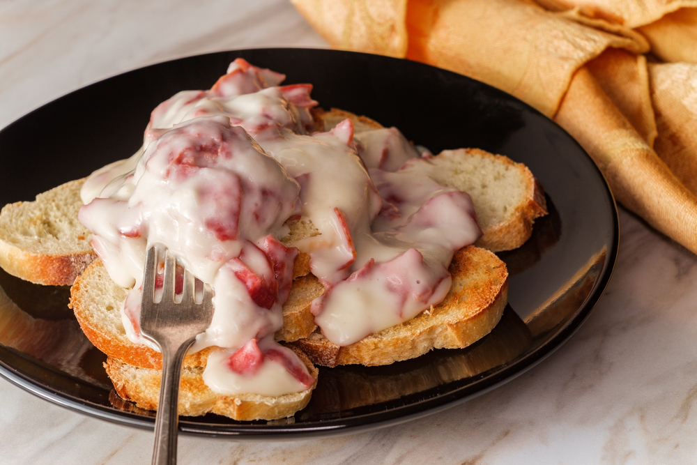Creamed and chipped beef on sliced toast on marble kitchen table also known as S.O.S.

