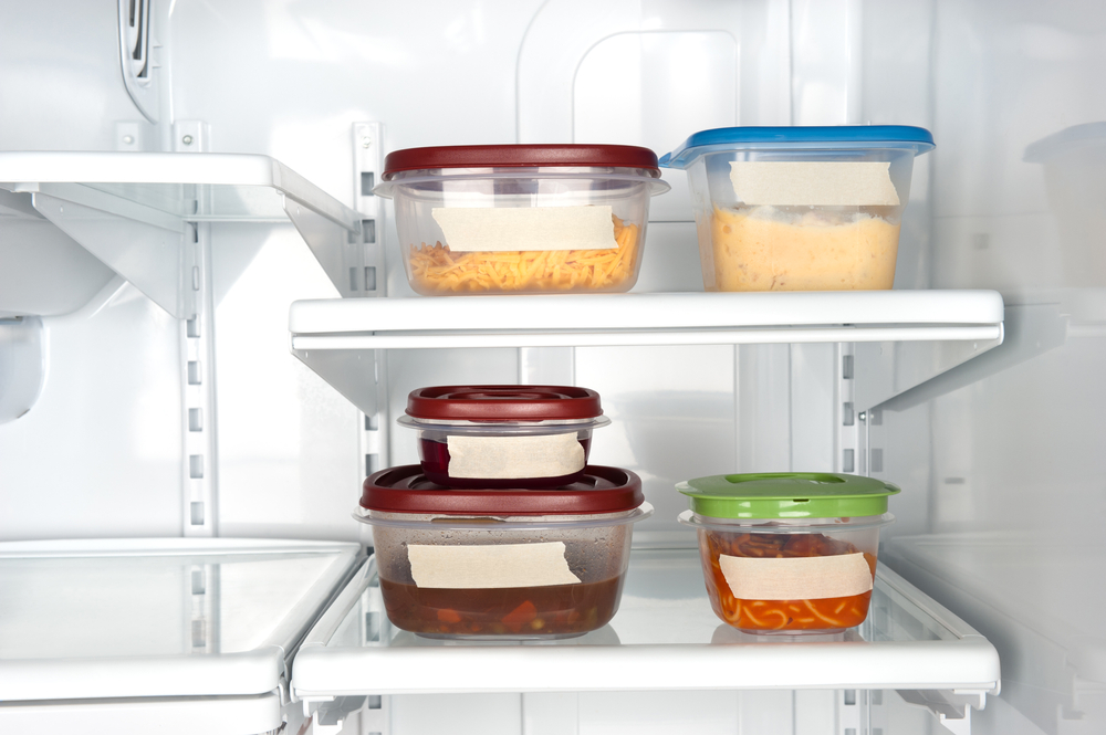 Leftovers in a refrigerator with blank tape for copy.
