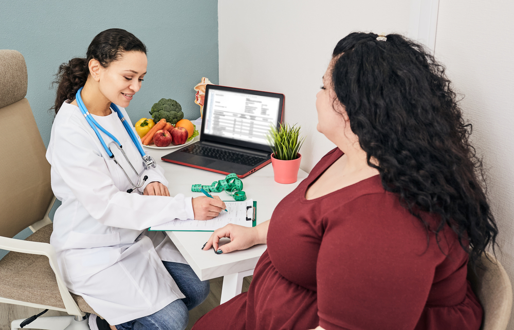 Obesity, unhealthy weight. Nutritionist calculating body mass index of fat woman for obesity treatment