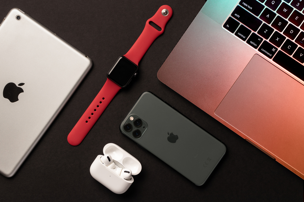 Lahore, Pakistan - May 13th, 2021: Flat Lay of different apple products on a grey background.