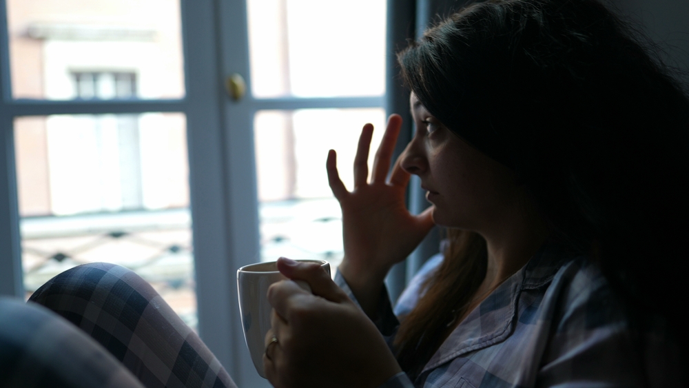 woman drinking coffee in bed