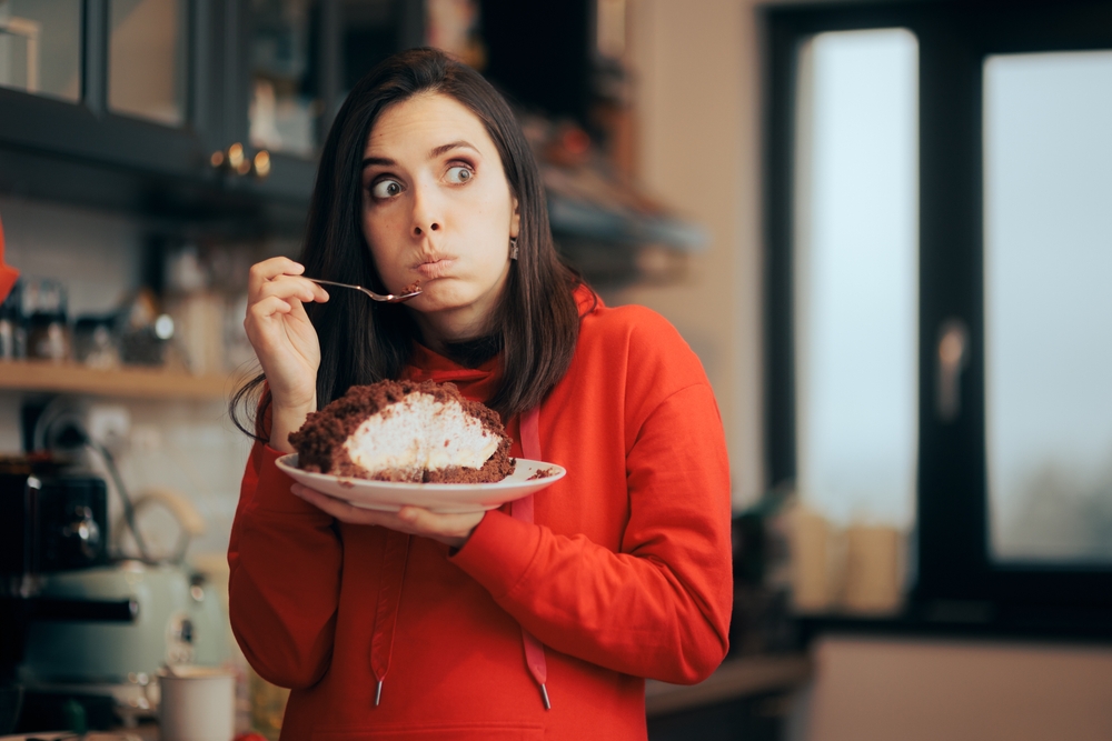 Funny Woman Feeling Guilty Eating Cake Cheating Diet. Tired girlfriend listening to her boring date feeling somnolent