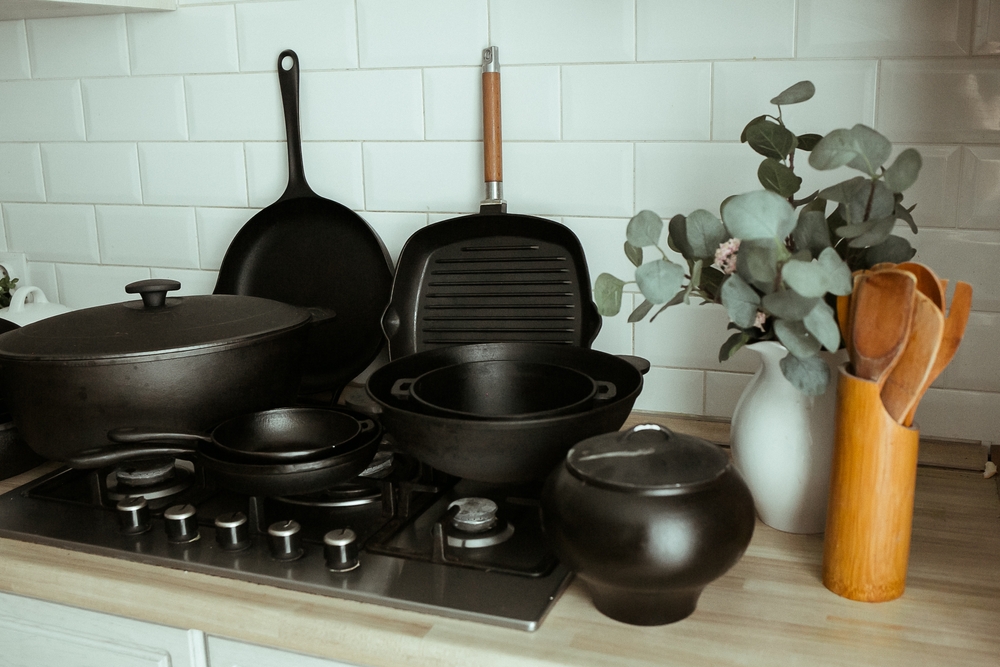 Composition from a set of cast-iron utensils. Cast iron for home use. Cooking in cast iron cookware.
