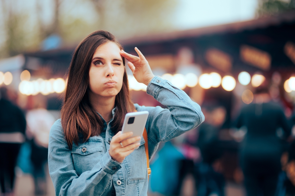 Forgetful Woman using Phone App as Reminder. Puzzled person organizing her life using a digital planner on her smartphone
